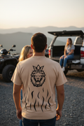 Close-up of King Tiger shirt back with woman beside him and woman on truck tailgate in mountain setting