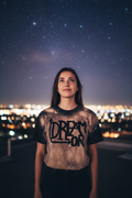 Dream ON front shot woman on rooftop under stars
